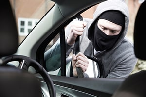 Masked Man Breaking Into Car With Crowbar